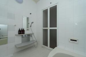 a white bathroom with a shower and a toilet at Shibi in Nara +48 photos