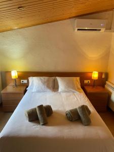 a large white bed with two pillows on it at EVA & TRAVEL - CAL MARCEL - Habitacion in Prades