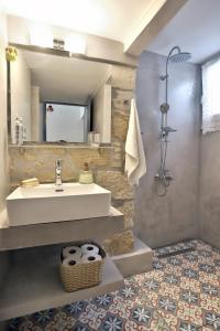 a bathroom with a sink and a shower at Mom’s home in Sitia