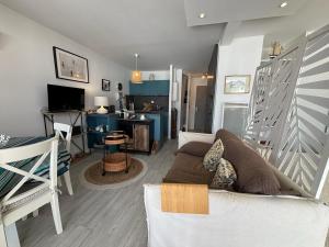 a living room with a couch and a table at Charmant 2 pièces à Hendaye avec WiFi - FR-1-239-1105 in Hendaye