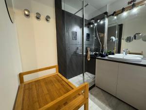 a bathroom with a shower and a sink and a bench at Charmant 2 pièces à Hendaye avec WiFi - FR-1-239-1105 in Hendaye +7 photos