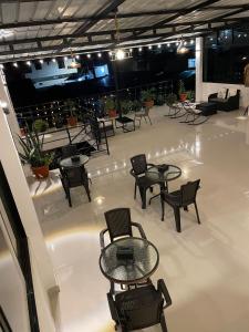 a room with tables and chairs on a white floor at Las lomas de Fonavi in Tarapoto