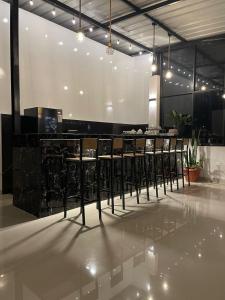 a restaurant with a bar with black stools at Las lomas de Fonavi in Tarapoto