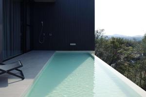 a swimming pool with a shower in a house at KITOW private villa in Awaji
