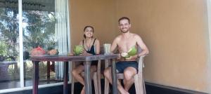 a man and a woman sitting at a table at Peacock Lake Villa in Habarana +53 photos