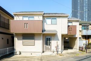 a white house with a brown roof at 2025 Reno'd Japanese House in Musashi-Kosugi 15PAX in Kawasaki