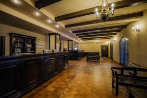a large room with a bar in a building at The Nook in Pădureni