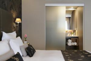 a hotel room with two beds and a mirror at The Y Hotel in Athens