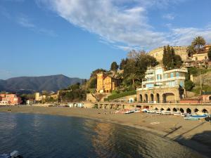 a beach with buildings and people on the beach at Agriturismo Villa Caterina in Levanto +43 photos