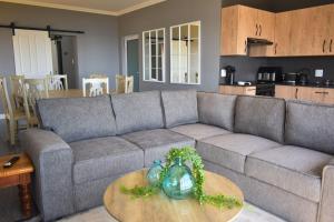 a living room with a couch and a table at Hartklop Luxury Self Catering Guesthouse in Linkside