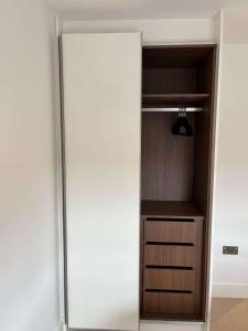 a white refrigerator in a room at Two-Bedroom Apartment with City View in Birmingham