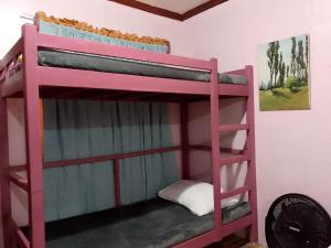 a red bunk bed in a room at Little Bridges in Mambajao