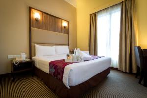 a hotel room with a large bed and a window at Hotel Sentral Kuala Lumpur at KL Sentral Station in Kuala Lumpur +31 photos