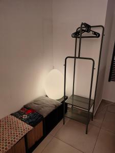 a small room with a bed and a lamp at Il nido di Luna in Turin