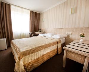 a hotel room with two beds and two lamps at Bukovyna Hotel in Chernivtsi