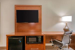 a room with a desk with a microwave and a tv at City Express by Marriott Yulee in Yulee +45 photos