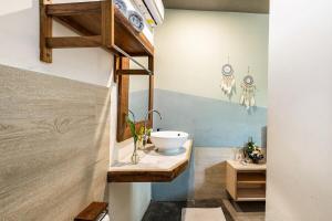 a bathroom with a bowl sink on a counter at Villa The Jambu in Tumbak Bayuh +45 photos