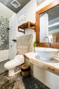 a bathroom with a sink and a toilet at Villa The Jambu in Tumbak Bayuh