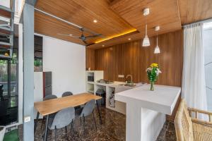 a kitchen and dining room with a table and chairs at Sahadewa 46 - Dreamland Golf Complex 4 Bedroom in Uluwatu