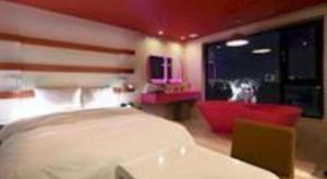 a bedroom with a bed and a chair and a tv at Circle Hotel Seoul in Seoul