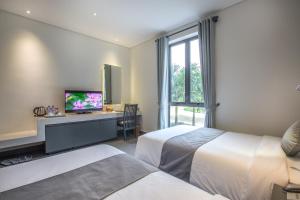 Postel nebo postele na pokoji v ubytování Thanh Tan Hot Springs By Fusion