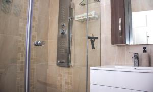 a shower with a glass door next to a sink at No5 on Golden Sands in Margate +22 photos