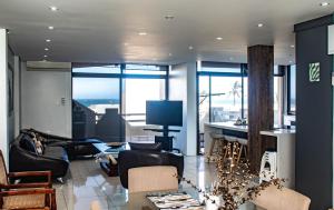 a living room with black furniture and a fireplace at No5 on Golden Sands in Margate