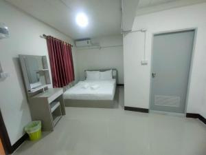 a small room with a bed and a mirror at Mani Residence in Udon Thani