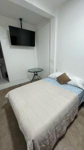 a bedroom with a bed with a tv on the wall at Casa Luna Bonita in Cabo San Lucas +15 photos