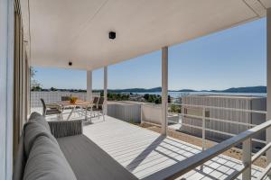 a balcony of a house with a table and chairs at Sensus Aqua Villa Buqez in Drage
