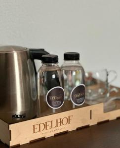 a wooden box with two glass bottles next to a appliance at Edelhof in Karagandy
