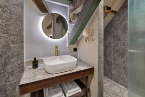 a bathroom with a sink and a mirror at The Saints Hotel in Den Bosch +38 photos
