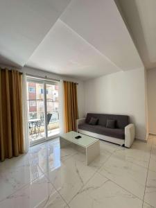 a living room with a couch and a table at Comfort 2BR Apartment near Beach & Café del Mar- By HostMT in St Paul's Bay +11 photos