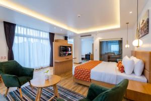 a hotel room with a bed and a living room at Hotel Anu in Kathmandu