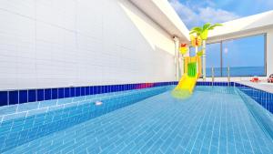 a swimming pool with a slide in the middle at Goseong Belossi Ayajin Kids Poolvilla in Goseong