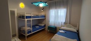 a small room with two bunk beds and a light at Casa La Rosa de los Vientos in Cobisa