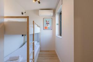 a room with two bunk beds and a staircase at Maison Nemo in Nieuwpoort