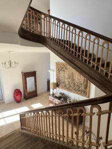 a staircase in a house with a living room at Château de Mauhic - 15th century in Loubédat