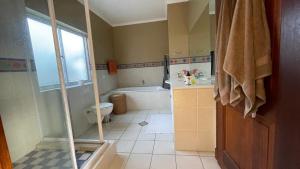 a bathroom with a shower and a toilet and a sink at Sunset Retreat in Cape Town +15 photos