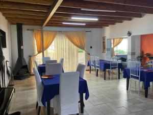 a dining room with blue tables and white chairs at Royal Olympia Lodges & Safaris RSA in Sandton