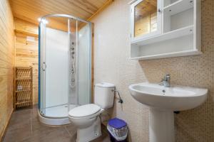 a bathroom with a toilet and a sink and a shower at Casa Faro in Camarles +19 photos