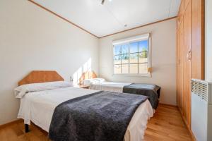 two beds in a room with a window at La Marquesa in Camarles +29 photos
