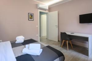 a bedroom with a bed and a desk and a computer at Domus Maria in Rome