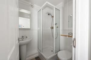 a bathroom with a shower and a toilet and a sink at Bay View, Compass Point, Carbis Bay, St Ives in Carbis Bay +25 photos