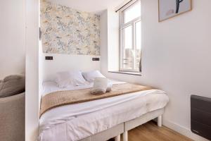 Posteľ alebo postele v izbe v ubytovaní Le Bras d'or Apparts et Spa