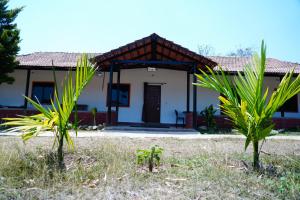 a house in the middle of a field at Trogon resort in Kabini River