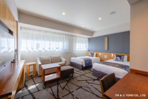 a hotel room with two beds and a desk at Hotel Gracery Shinjuku in Tokyo +37 photos