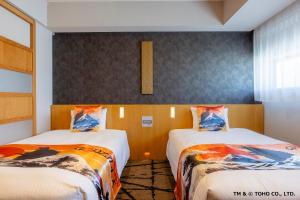 a room with two beds in a room at Hotel Gracery Shinjuku in Tokyo