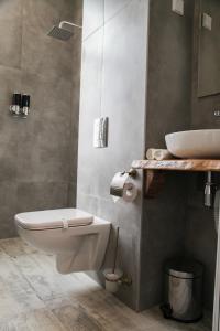 a bathroom with a white toilet and a sink at Corner House in Lovech +88 photos