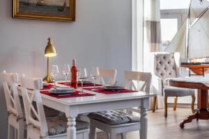 a dining room table with wine glasses on it at App Lolita in Kühlungsborn
